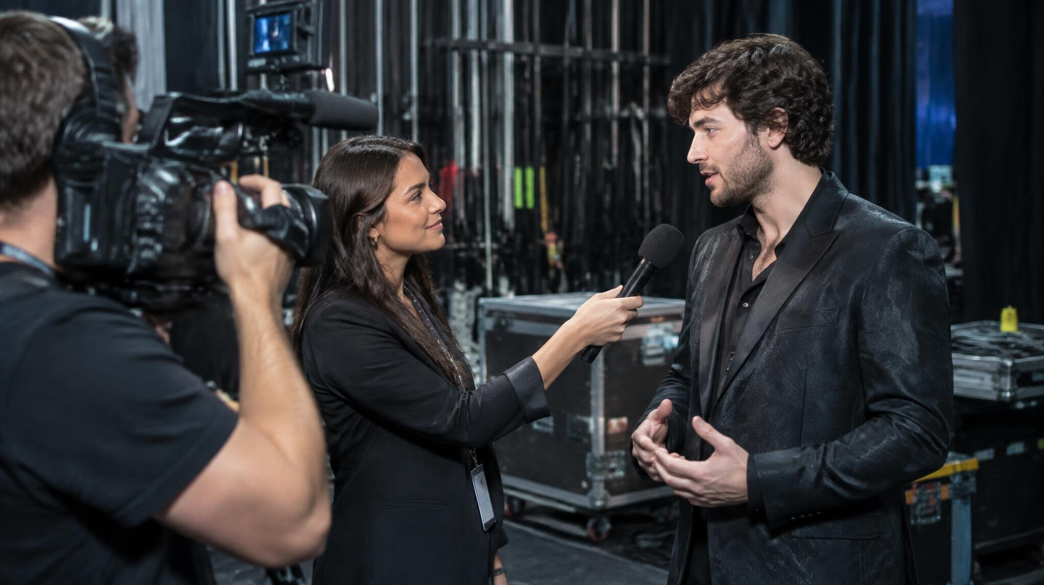 Backstage interview being filmed with handheld microphone
