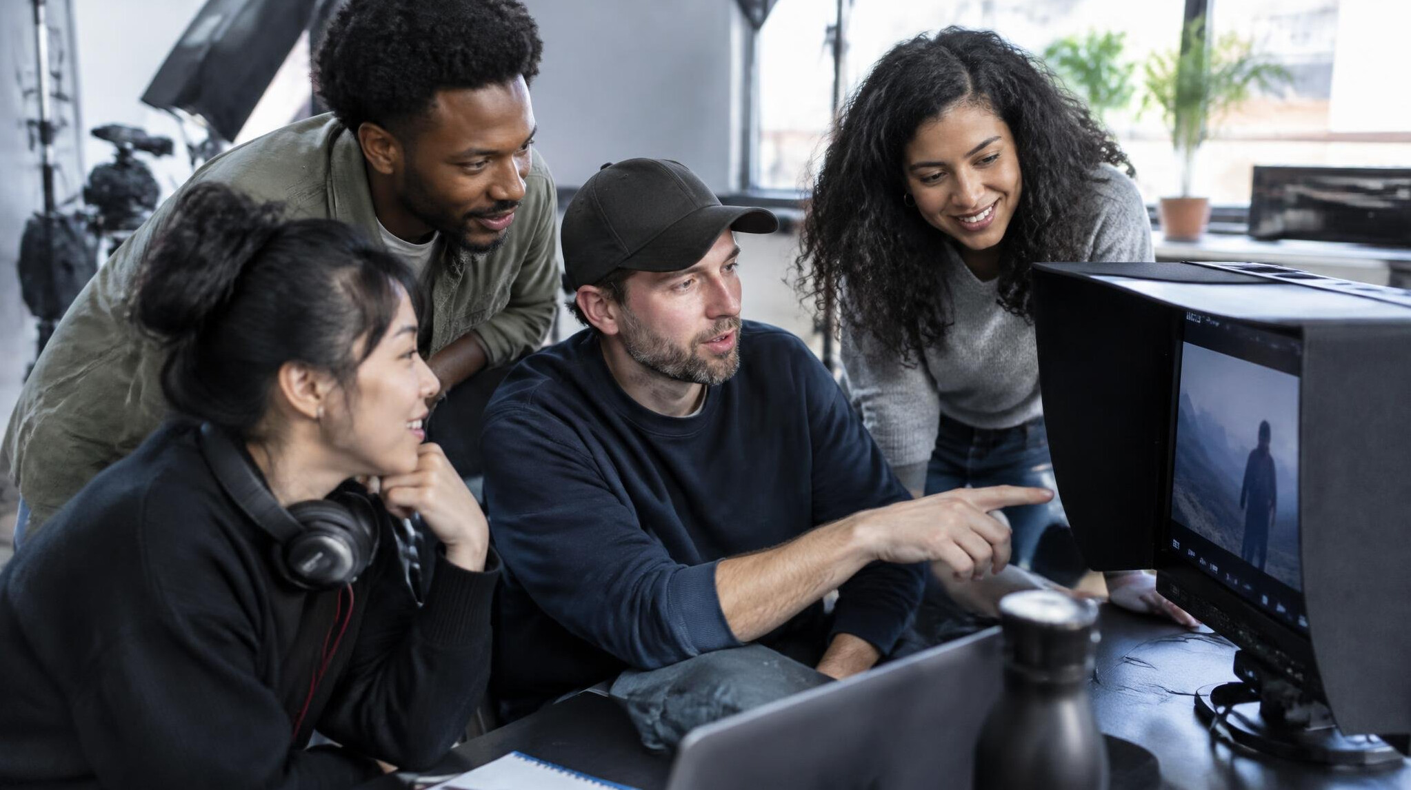 Production team reviewing footage in a media studio